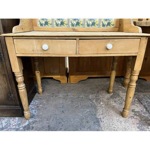 54 - A Victorian pine wash stand with two drawers and ceramic tile inserts