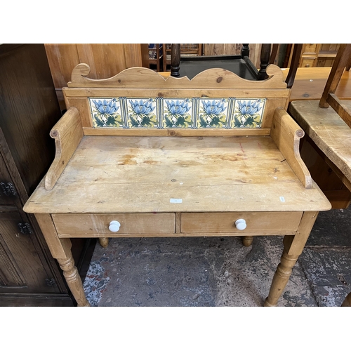 54 - A Victorian pine wash stand with two drawers and ceramic tile inserts