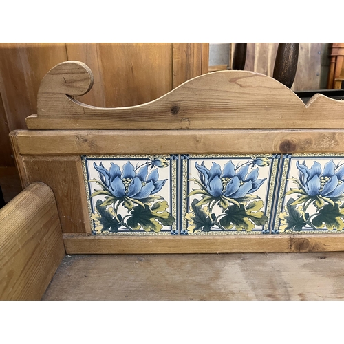 54 - A Victorian pine wash stand with two drawers and ceramic tile inserts