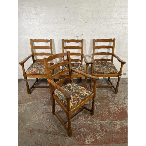 55 - Four 17th century style oak and tapestry upholstered ladder back carver dining chairs