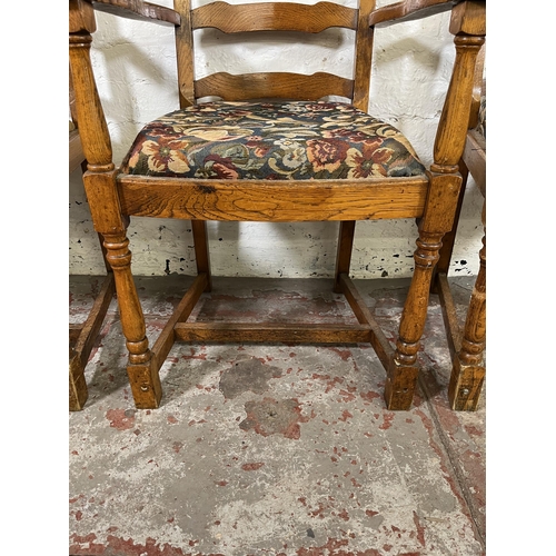 55 - Four 17th century style oak and tapestry upholstered ladder back carver dining chairs