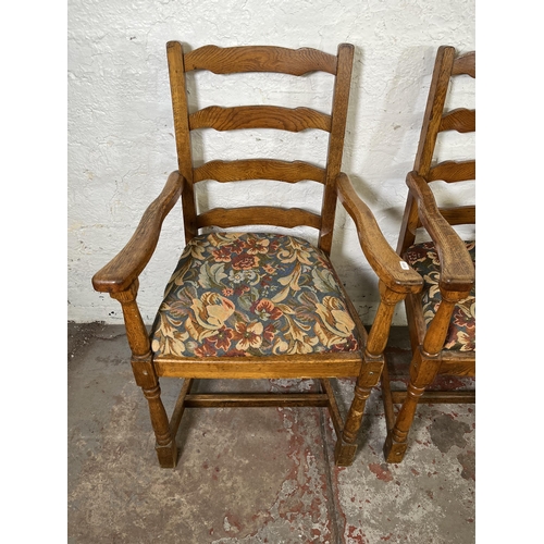 55 - Four 17th century style oak and tapestry upholstered ladder back carver dining chairs