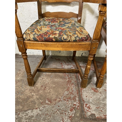 55 - Four 17th century style oak and tapestry upholstered ladder back carver dining chairs