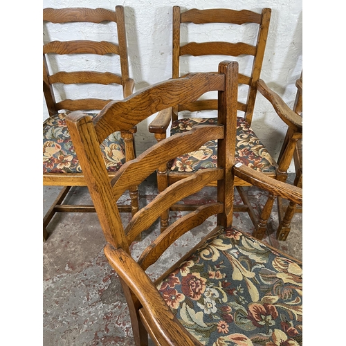 55 - Four 17th century style oak and tapestry upholstered ladder back carver dining chairs