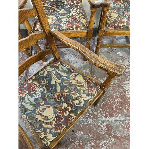 55 - Four 17th century style oak and tapestry upholstered ladder back carver dining chairs