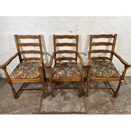 55 - Four 17th century style oak and tapestry upholstered ladder back carver dining chairs