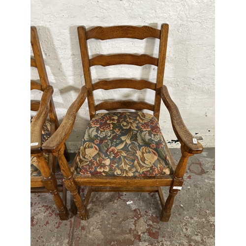 55 - Four 17th century style oak and tapestry upholstered ladder back carver dining chairs