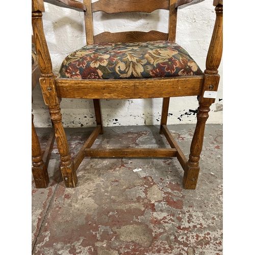 55 - Four 17th century style oak and tapestry upholstered ladder back carver dining chairs