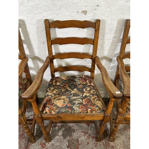 55 - Four 17th century style oak and tapestry upholstered ladder back carver dining chairs