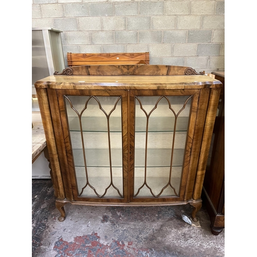 59 - A walnut display cabinet with two glazed doors, two glass shelves and cabriole supports