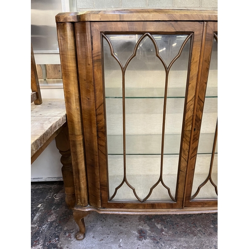 59 - A walnut display cabinet with two glazed doors, two glass shelves and cabriole supports