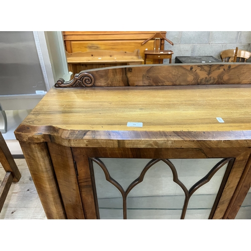 59 - A walnut display cabinet with two glazed doors, two glass shelves and cabriole supports