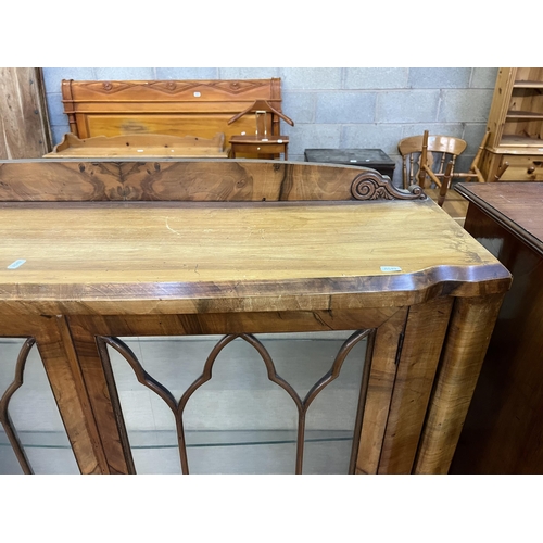 59 - A walnut display cabinet with two glazed doors, two glass shelves and cabriole supports