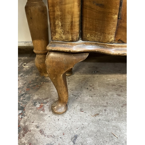 59 - A walnut display cabinet with two glazed doors, two glass shelves and cabriole supports