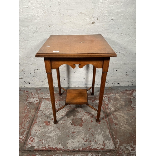 69 - An Arts & Crafts oak side table with lower shelf