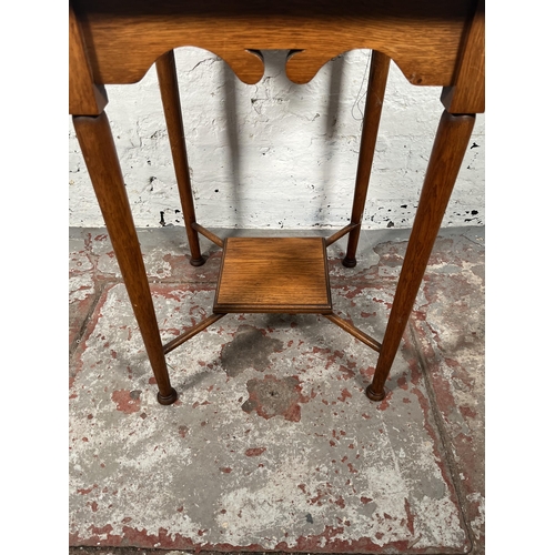 69 - An Arts & Crafts oak side table with lower shelf