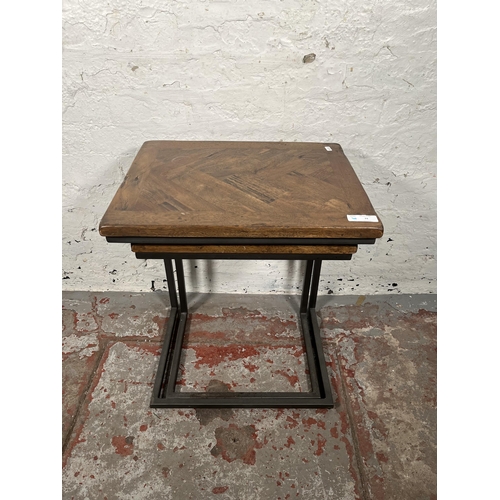 74 - A modern oak and black metal nest of two tables