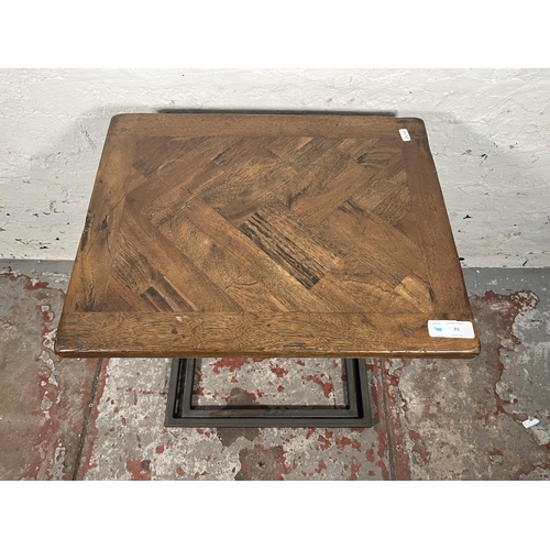 74 - A modern oak and black metal nest of two tables