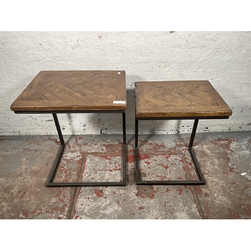 74 - A modern oak and black metal nest of two tables