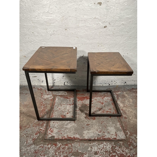 74 - A modern oak and black metal nest of two tables