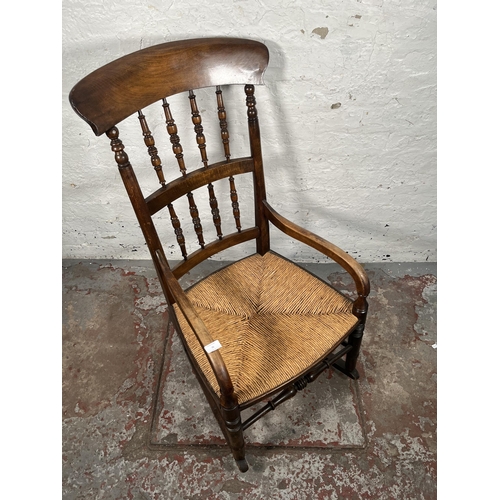 76 - A 19th century beech and rush seated spindle back farmhouse rocking chair