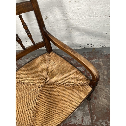 76 - A 19th century beech and rush seated spindle back farmhouse rocking chair