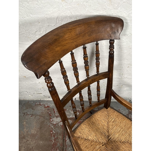 76 - A 19th century beech and rush seated spindle back farmhouse rocking chair