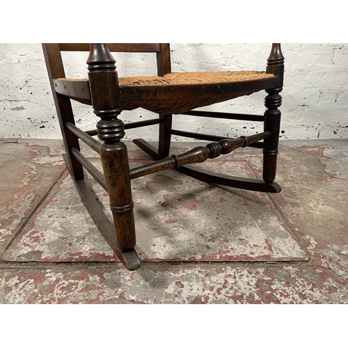 76 - A 19th century beech and rush seated spindle back farmhouse rocking chair