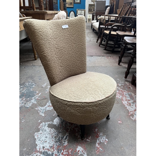 81 - A mid 20th century fabric upholstered bedroom chair with ebonised splayed supports