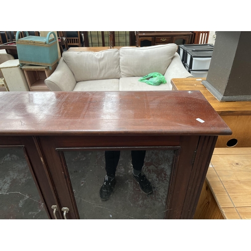 83 - A Victorian mahogany bookcase with two glazed doors and three shelves