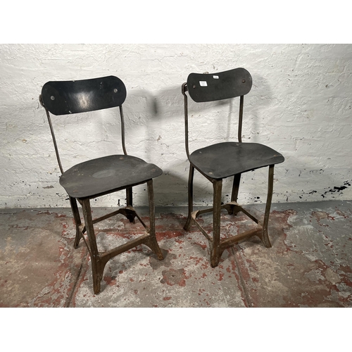 85A - A pair of 1950s Tan-Sad style fibreboard and cast metal industrial factory chairs