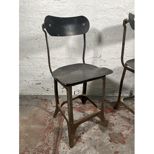 85A - A pair of 1950s Tan-Sad style fibreboard and cast metal industrial factory chairs