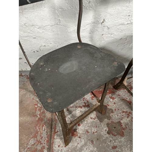 85A - A pair of 1950s Tan-Sad style fibreboard and cast metal industrial factory chairs