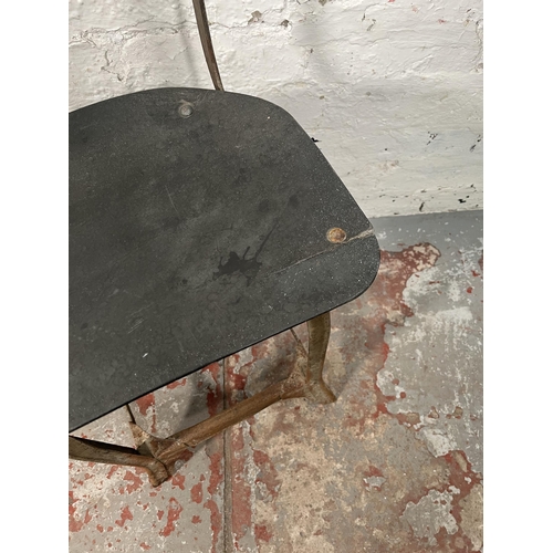 85A - A pair of 1950s Tan-Sad style fibreboard and cast metal industrial factory chairs