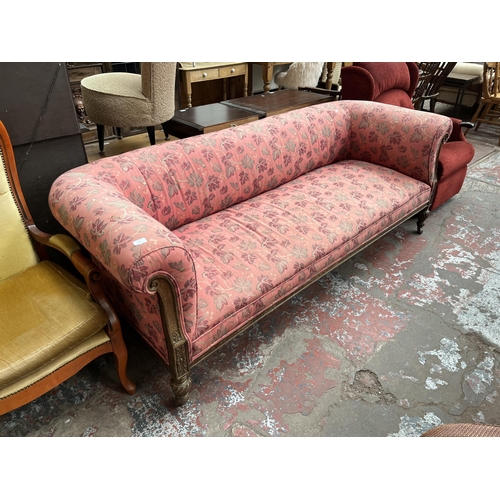 90 - A Victorian carved oak and fabric upholstered three seater sofa