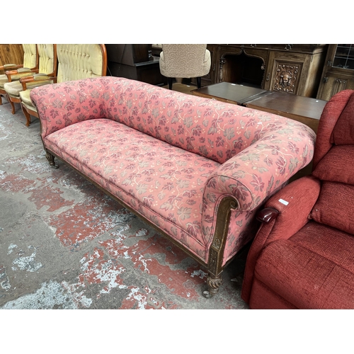 90 - A Victorian carved oak and fabric upholstered three seater sofa