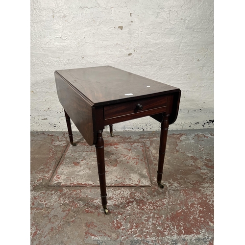 93 - A Georgian mahogany drop leaf Pembroke table with brass castors