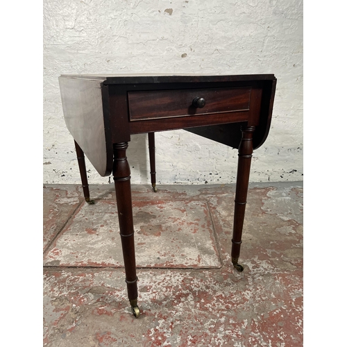 93 - A Georgian mahogany drop leaf Pembroke table with brass castors