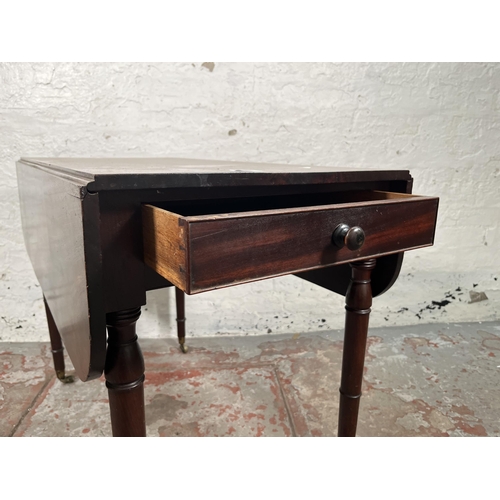 93 - A Georgian mahogany drop leaf Pembroke table with brass castors