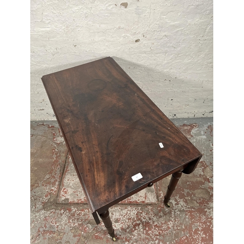 93 - A Georgian mahogany drop leaf Pembroke table with brass castors