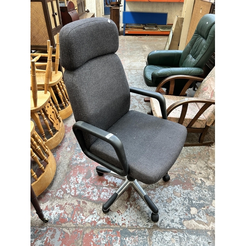 102 - A black fabric and plastic swivel office desk chair