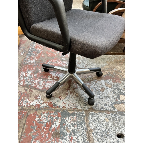 102 - A black fabric and plastic swivel office desk chair