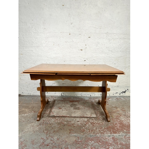 103 - An oak rectangular trestle dining table