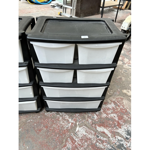 111 - Two plastic six drawer storage towers on castors