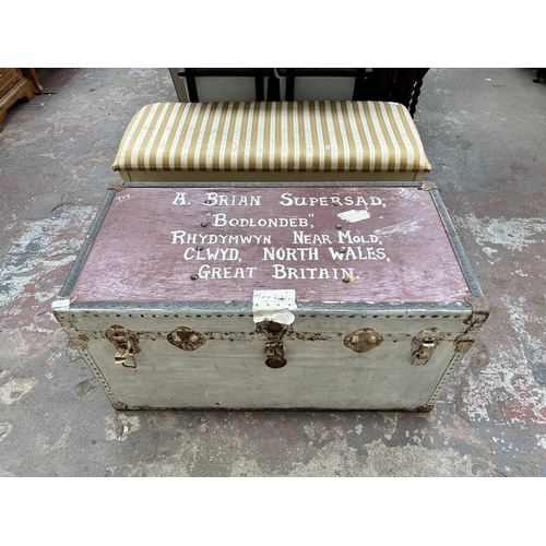 113 - An early 20th century painted travel trunk with contents