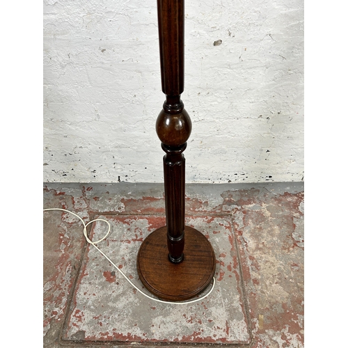 114 - A mahogany standard lamp with circular base and reeded column - approx. 160cm high