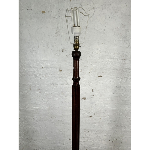 114 - A mahogany standard lamp with circular base and reeded column - approx. 160cm high