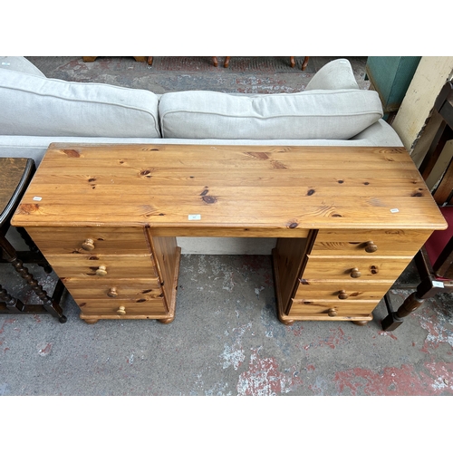 117 - A pine dressing table with eight drawers