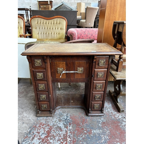 119 - A late 19th/early 20th century mahogany and walnut kneehole desk with tan leather writing surface