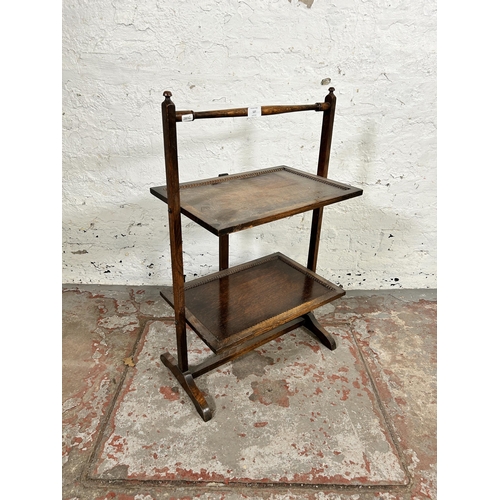 127 - An early 20th century beaded oak two tier folding side table